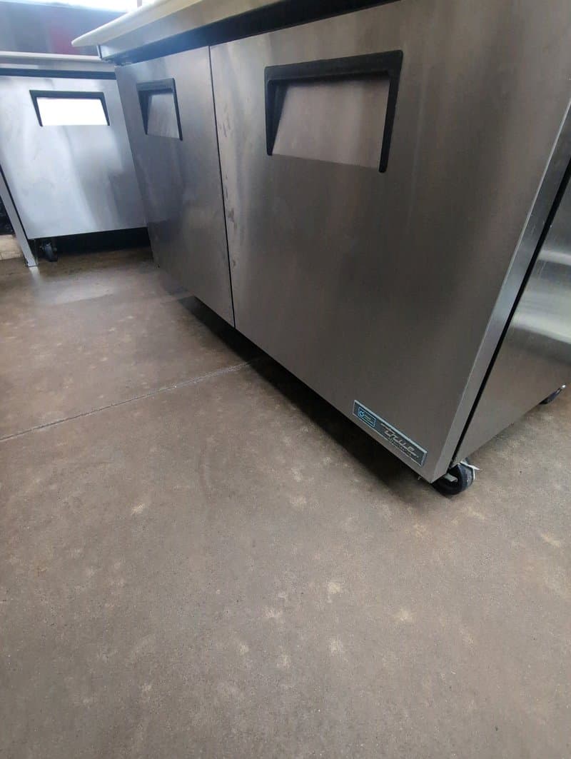 Undercounter commercial refrigerator being serviced at a Calgary food-service location