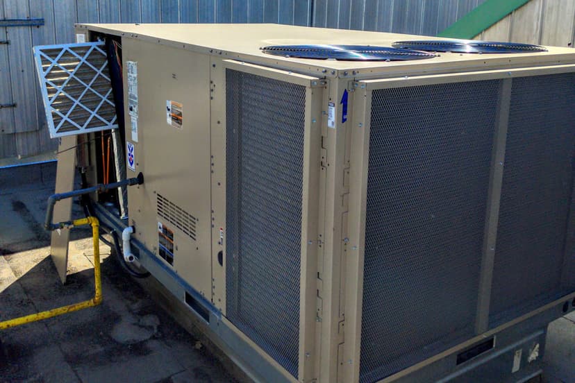 HVAC technician on rooftop unit